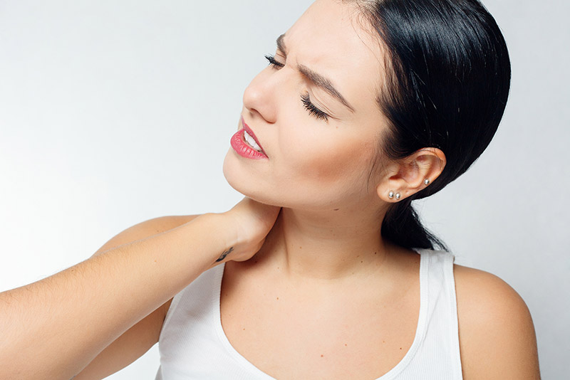 Woman with sore neck from Torticollis in Scottsdale AZ